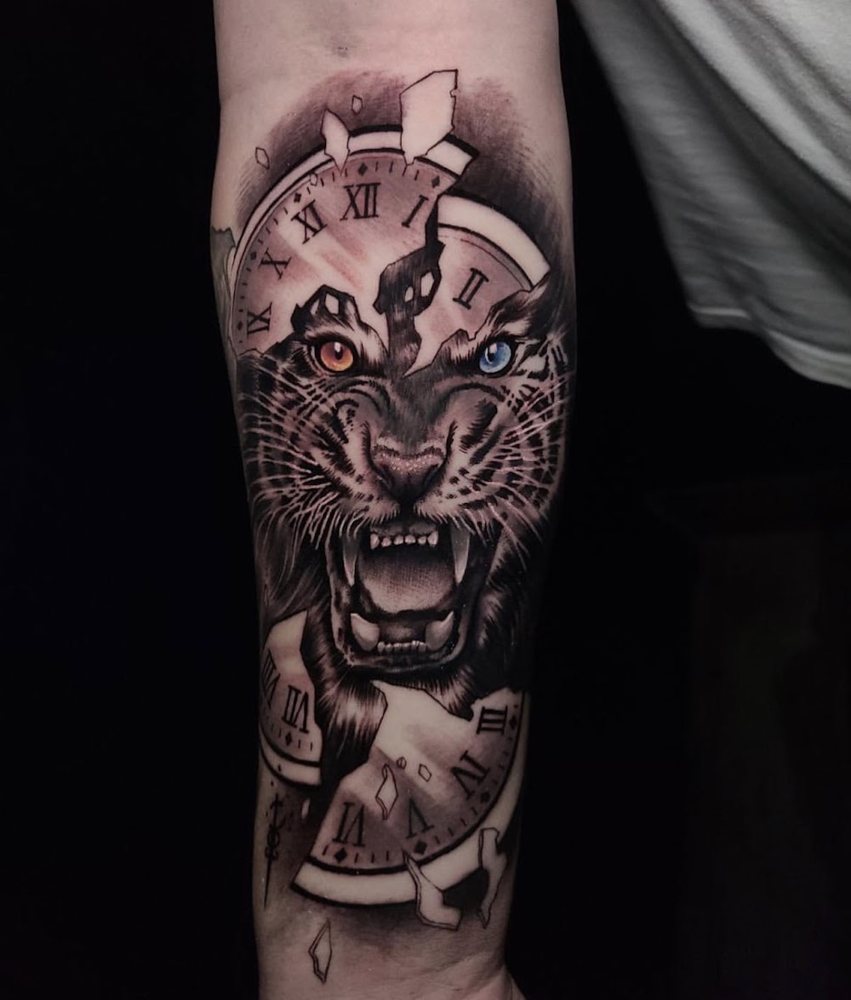 Black and grey realism tiger with shattered clock, forearm